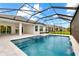 A beautiful screened-in pool with a spa and travertine tile surround offers the perfect place to unwind at 15817 San Lazzaro Ave, Bradenton, FL 34211