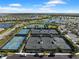 Aerial view of tennis courts in a well-maintained community with landscaping and parking at 15817 San Lazzaro Ave, Bradenton, FL 34211