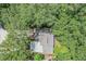 An aerial view of the home showcases lush, mature trees surrounding the property providing privacy at 1608 E Linden Ave, Tampa, FL 33604