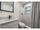 Modern bathroom features white tile, black hardware, and a sleek vanity at 1608 E Linden Ave, Tampa, FL 33604