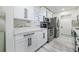 Updated kitchen with white cabinets, stainless steel appliances, and modern countertops at 1608 E Linden Ave, Tampa, FL 33604