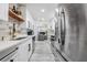 Modern kitchen featuring stainless steel appliances, wood floors, and marble backsplash at 1608 E Linden Ave, Tampa, FL 33604