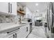 Modern kitchen with white countertops, wood floors, and marble backsplash at 1608 E Linden Ave, Tampa, FL 33604