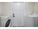 Convenient laundry area with a washer, dryer, and a door leading outside at 1608 E Linden Ave, Tampa, FL 33604