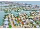 A stunning aerial view of a home in a vibrant neighborhood with waterfront access and city views at 17595 1St E St, Redington Shores, FL 33708