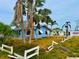 A blue home with palm trees in the front yard at 17595 1St E St, Redington Shores, FL 33708