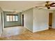 An open living room with neutral paint, tile floors, and ceiling fans for a comfortable living space at 17595 1St E St, Redington Shores, FL 33708