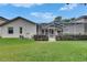 Backyard view with screened pool and well-kept lawn at 17711 Hampshire Oak Dr, Tampa, FL 33647