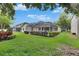 Expansive backyard with a screened pool area and manicured hedges at 17711 Hampshire Oak Dr, Tampa, FL 33647