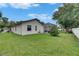 Lush backyard featuring green grass and mature landscaping at 17711 Hampshire Oak Dr, Tampa, FL 33647