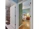 View from hallway to a bathroom featuring tiled floors and shower with patterned curtain at 17711 Hampshire Oak Dr, Tampa, FL 33647
