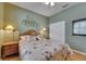 Cozy bedroom featuring a floral bedspread, decorative wall art, and a ceiling fan at 17711 Hampshire Oak Dr, Tampa, FL 33647