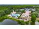 Community pool, clubhouse and tennis courts with lush trees and water view at 17711 Hampshire Oak Dr, Tampa, FL 33647
