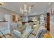 Elegant dining area with a glass table, upholstered chairs, and a decorative chandelier at 17711 Hampshire Oak Dr, Tampa, FL 33647
