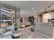 Open concept dining area with modern lighting fixture and view of the outdoor patio and pool at 17711 Hampshire Oak Dr, Tampa, FL 33647