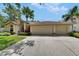 Inviting home exterior featuring an arched window, spacious driveway, and manicured landscaping at 17711 Hampshire Oak Dr, Tampa, FL 33647