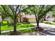 Charming home with landscaped front yard, lush green grass, and three-car garage at 17711 Hampshire Oak Dr, Tampa, FL 33647