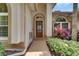 Home's front door entrance and landscaping featuring lovely plants at 17711 Hampshire Oak Dr, Tampa, FL 33647