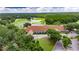 Aerial view of golf course, pond, and a well-manicured landscape at 17711 Hampshire Oak Dr, Tampa, FL 33647