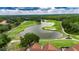 Expansive golf course with lush green fairways, sand traps, and a large pond, perfect for recreation and relaxation at 17711 Hampshire Oak Dr, Tampa, FL 33647