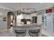 Bright kitchen features granite counters, a hanging pot rack, stainless steel appliances, and white cabinetry at 17711 Hampshire Oak Dr, Tampa, FL 33647