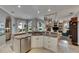Well-lit kitchen featuring granite countertops, white cabinetry, and a view of the living area at 17711 Hampshire Oak Dr, Tampa, FL 33647