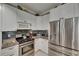 Close up of a modern kitchen featuring stainless steel appliances, granite countertops, and stylish tile backsplash at 17711 Hampshire Oak Dr, Tampa, FL 33647