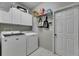 Laundry room with front loading washer and dryer and storage shelves at 17711 Hampshire Oak Dr, Tampa, FL 33647
