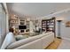 Bright living room with built-in shelving, hardwood floors, and a comfortable seating area at 17711 Hampshire Oak Dr, Tampa, FL 33647