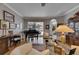 Sunlit living area featuring a piano and an adjacent formal dining room with glass table at 17711 Hampshire Oak Dr, Tampa, FL 33647