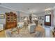 Open-concept living room with comfortable seating, a chandelier, and a decorative display cabinet at 17711 Hampshire Oak Dr, Tampa, FL 33647