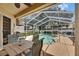 Enclosed pool area featuring a private pool, covered lanai, and ample seating for outdoor relaxation and entertainment at 17711 Hampshire Oak Dr, Tampa, FL 33647