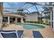Inviting screened-in pool with ample seating for relaxing and entertaining at 17711 Hampshire Oak Dr, Tampa, FL 33647