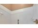 Close-up of a white tiled shower with a soap dish, grab bar, and clear glass shower door at 17711 Hampshire Oak Dr, Tampa, FL 33647
