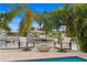 Tranquil outdoor seating area complete with fire pit, water views, and lush tropical landscaping at 1960 Montana Ne Ave, St Petersburg, FL 33703