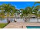 Dock over looking calm waters bordered by tropical landscaping at 1960 Montana Ne Ave, St Petersburg, FL 33703