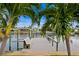 A wooden dock featuring a bench and a boat lift stretches out over the canal to provide water access at 1960 Montana Ne Ave, St Petersburg, FL 33703
