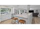 Open kitchen with marble countertops, white cabinets, stainless steel appliances, and wood look floors at 1960 Montana Ne Ave, St Petersburg, FL 33703