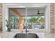 Kitchen sink with a view of the patio, pool, and lush tropical landscaping at 1960 Montana Ne Ave, St Petersburg, FL 33703