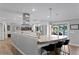 Modern kitchen featuring a marble island with seating, stainless steel appliances, and an open layout at 1960 Montana Ne Ave, St Petersburg, FL 33703