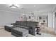 Open-concept living room with a sectional sofa, kitchen island, and modern lighting fixtures at 1960 Montana Ne Ave, St Petersburg, FL 33703