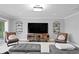 Comfortable living room with a large sectional sofa, modern television, and stylish decorative shelves at 1960 Montana Ne Ave, St Petersburg, FL 33703