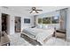 Serene main bedroom with ensuite bathroom, ceiling fan and large windows with palm tree views at 1960 Montana Ne Ave, St Petersburg, FL 33703