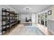 Spacious home office with built-in shelving, modern lighting, and sliding doors to the outdoor space at 1960 Montana Ne Ave, St Petersburg, FL 33703
