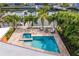 Aerial view of pool with jacuzzi, outdoor seating, firepit and tropical landscaping at 1960 Montana Ne Ave, St Petersburg, FL 33703