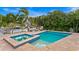 An inviting pool and spa with water views, surrounded by lush tropical landscaping and comfortable seating at 1960 Montana Ne Ave, St Petersburg, FL 33703