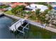 Waterfront home with dock and boat lift surrounded by beautiful tropical landscaping at 1960 Montana Ne Ave, St Petersburg, FL 33703