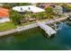 Waterfront house with dock and boat lift nestled among lush palm trees at 1960 Montana Ne Ave, St Petersburg, FL 33703