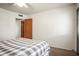 Bedroom features a ceiling fan, bed, and neutral carpeted flooring at 230 Portree Dr, Dunedin, FL 34698