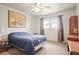 Bright bedroom with a comfortable bed, wooden furniture, and window with view under a ceiling fan at 230 Portree Dr, Dunedin, FL 34698